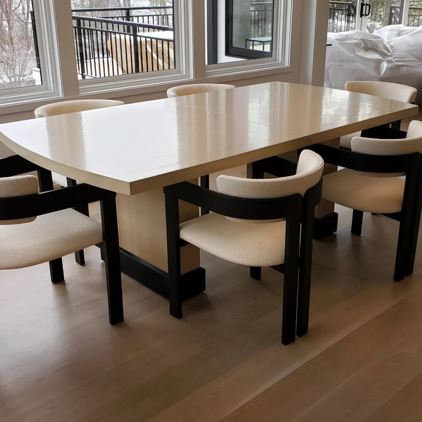 Dark-wood dining table with orange upholstered chairs on a hardwood floor